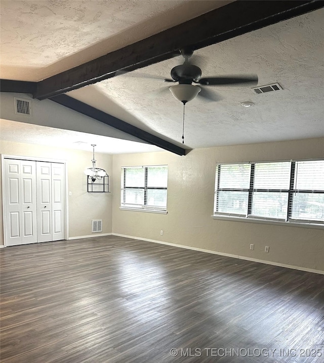 1607 Kay, Durant, OK 74701 - unfurnished dining area with dark wood finished floors, beamed ceiling, baseboards, a ceiling fan, and a textured ceiling