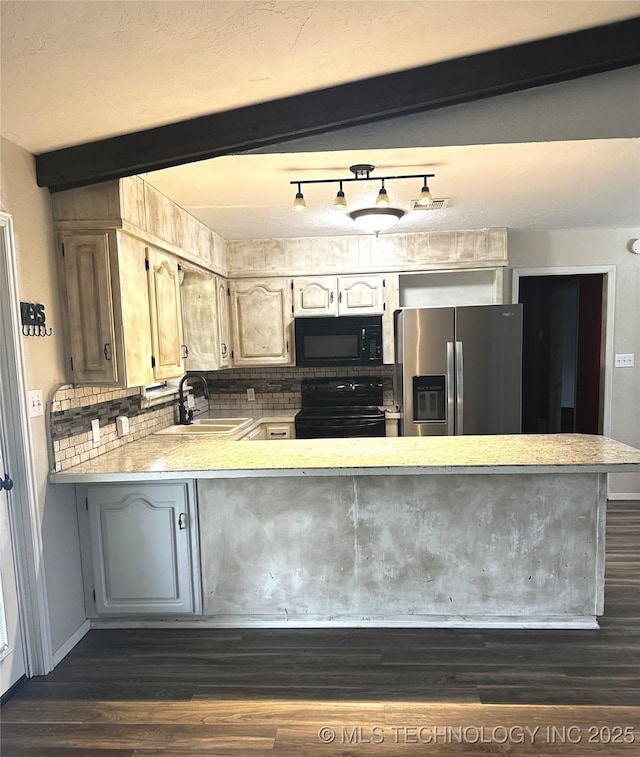 1607 Kay, Durant, OK 74701 - kitchen featuring black appliances, a sink, light countertops, dark wood-style flooring, and a peninsula