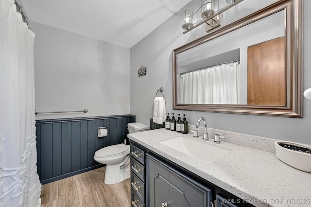 7626 Whispering Way, Kingston, OK 73439 - full bathroom featuring toilet, wainscoting, wood finished floors, and vanity