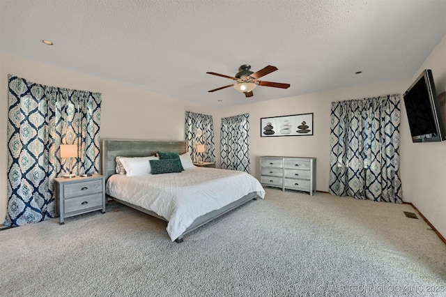 7626 Whispering Way, Kingston, OK 73439 - carpeted bedroom featuring a textured ceiling and ceiling fan