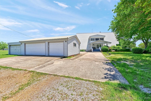 7626 Whispering Way, Kingston, OK 73439 - view of front of home with metal roof, a detached garage, a front lawn, and an outdoor structure
