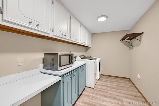 7626 Whispering Way, Kingston, OK 73439 - laundry room featuring washing machine and clothes dryer, baseboards, light wood-type flooring, and cabinet space