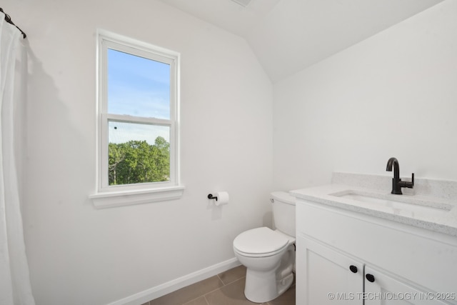 full bath with toilet, baseboards, tile patterned flooring, vanity, and vaulted ceiling