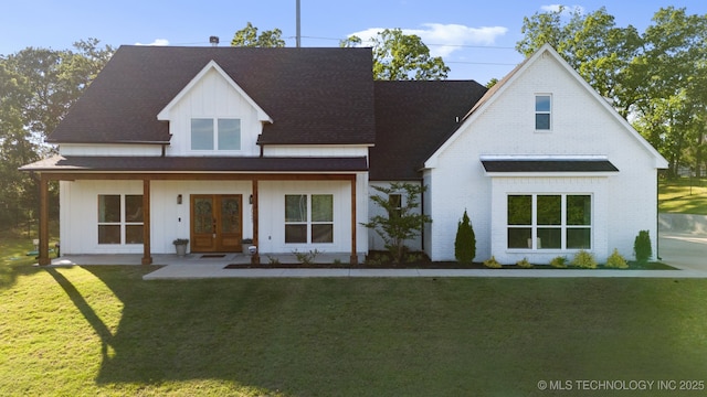 modern farmhouse style home with board and batten siding, brick siding, french doors, roof with shingles, and a front lawn