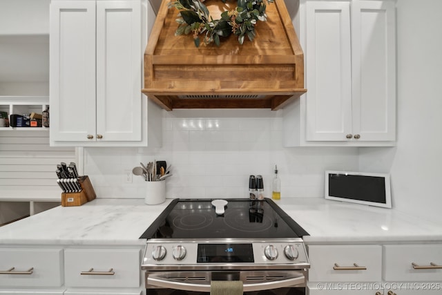 kitchen featuring white cabinetry, stainless steel electric range oven, light countertops, and custom range hood