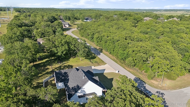 drone / aerial view featuring a forest view