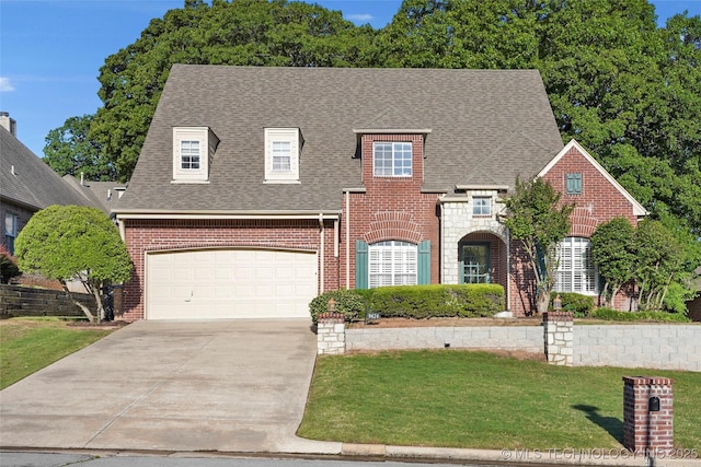 9624 S 68th E Ave, Tulsa, OK 74133 - traditional-style house with a shingled roof, concrete driveway, brick siding, and a front yard