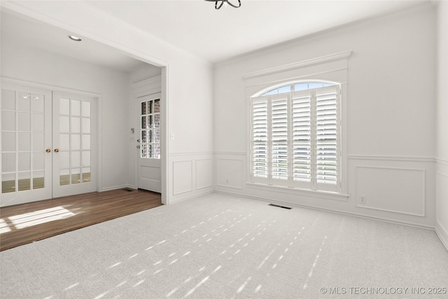 9624 S 68th E Ave, Tulsa, OK 74133 - interior space featuring a wainscoted wall, a decorative wall, french doors, and visible vents