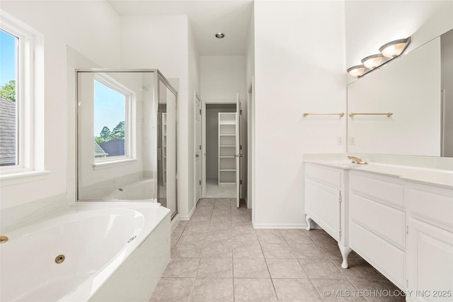 9624 S 68th E Ave, Tulsa, OK 74133 - full bathroom featuring a stall shower, tile patterned flooring, a jetted tub, vanity, and a spacious closet
