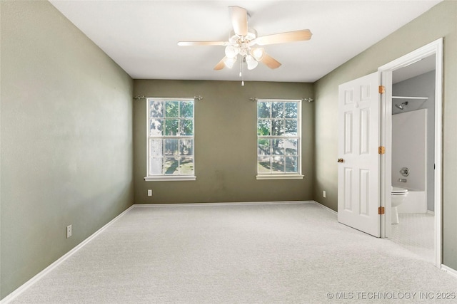 9624 S 68th E Ave, Tulsa, OK 74133 - unfurnished bedroom featuring baseboards, ensuite bathroom, carpet flooring, and a ceiling fan