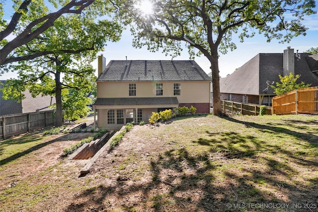 9624 S 68th E Ave, Tulsa, OK 74133 - rear view of property with a chimney, a fenced backyard, and a lawn
