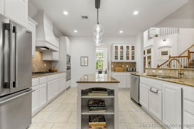 6811 S Sycamore Pl, Broken Arrow, OK 74011 - kitchen with appliances with stainless steel finishes, open shelves, a sink, custom range hood, and decorative backsplash