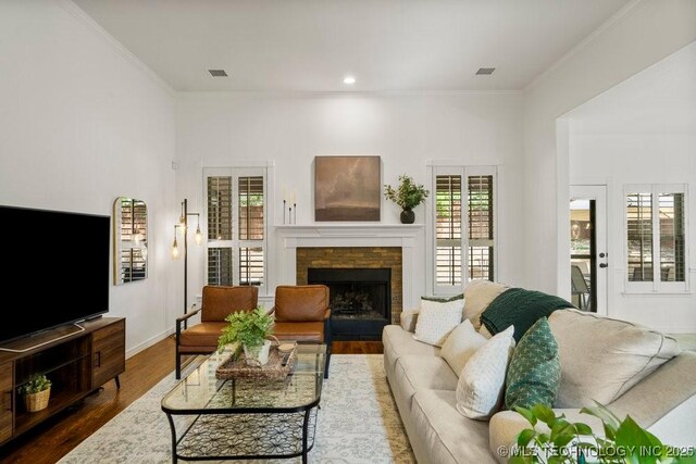 6811 S Sycamore Pl, Broken Arrow, OK 74011 - living area featuring ornamental molding, dark wood finished floors, a fireplace, recessed lighting, and baseboards