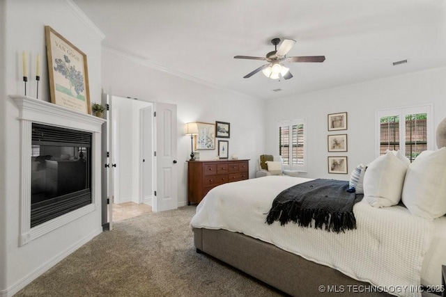 6811 S Sycamore Pl, Broken Arrow, OK 74011 - bedroom featuring carpet flooring, ornamental molding, a glass covered fireplace, a ceiling fan, and baseboards