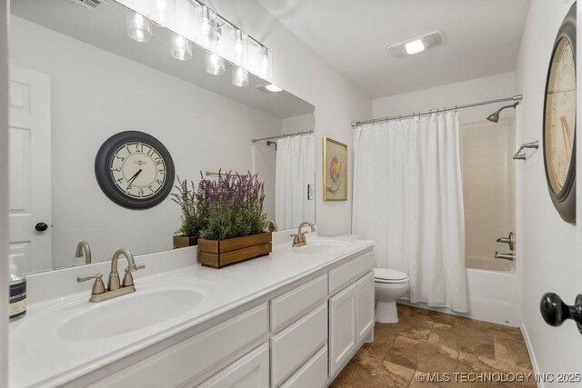 6811 S Sycamore Pl, Broken Arrow, OK 74011 - bathroom featuring toilet, shower / bath combo with shower curtain, double vanity, and stone finish flooring