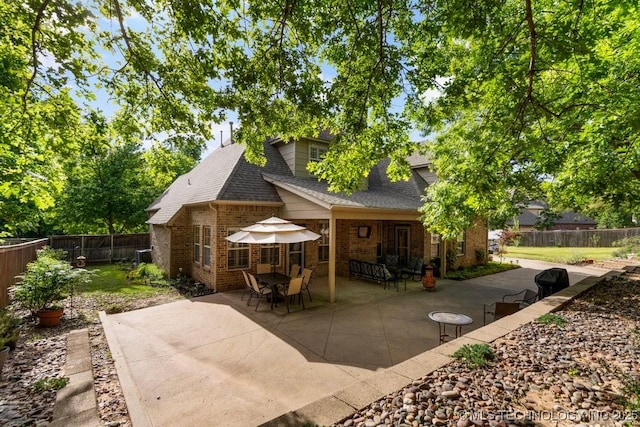 6811 S Sycamore Pl, Broken Arrow, OK 74011 - back of property featuring a patio area, brick siding, a fenced backyard, and roof with shingles