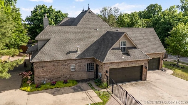 6811 S Sycamore Pl, Broken Arrow, OK 74011 - view of front of house featuring brick siding, an attached garage, concrete driveway, a chimney, and a shingled roof