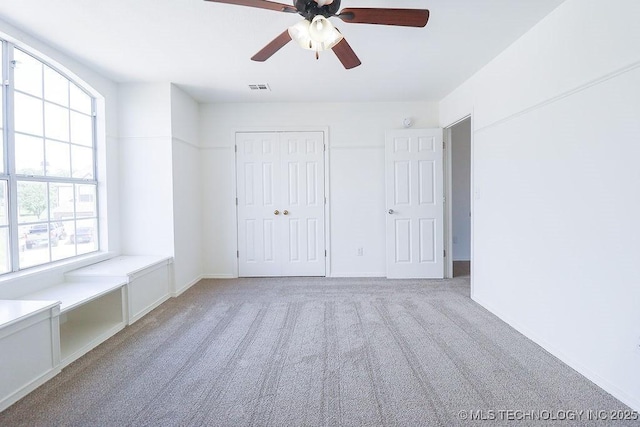 3934 S 199th E Ave, Broken Arrow, OK 74014 - unfurnished bedroom featuring multiple windows, light colored carpet, a closet, and a ceiling fan