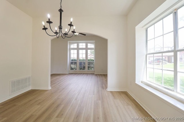 3934 S 199th E Ave, Broken Arrow, OK 74014 - unfurnished dining area featuring a chandelier, healthy amount of natural light, light wood-type flooring, and arched walkways