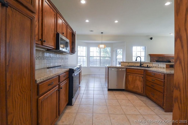 3934 S 199th E Ave, Broken Arrow, OK 74014 - kitchen with appliances with stainless steel finishes, backsplash, recessed lighting, brown cabinetry, and light stone counters