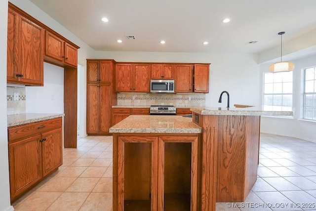 3934 S 199th E Ave, Broken Arrow, OK 74014 - kitchen with appliances with stainless steel finishes, backsplash, brown cabinetry, and recessed lighting