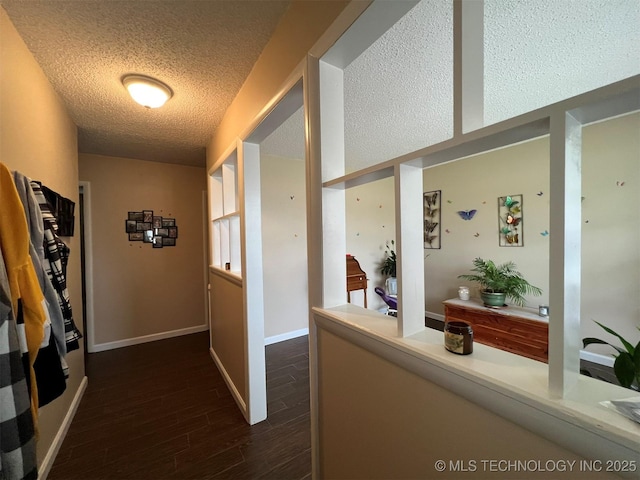 105 Hinton Blvd, Mannford, OK 74044 - corridor featuring dark wood finished floors, a textured ceiling, and baseboards