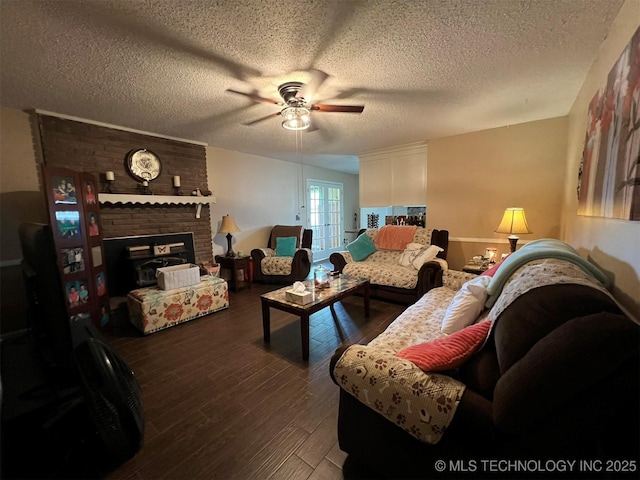 105 Hinton Blvd, Mannford, OK 74044 - living area featuring a fireplace, ceiling fan, a textured ceiling, and wood finished floors