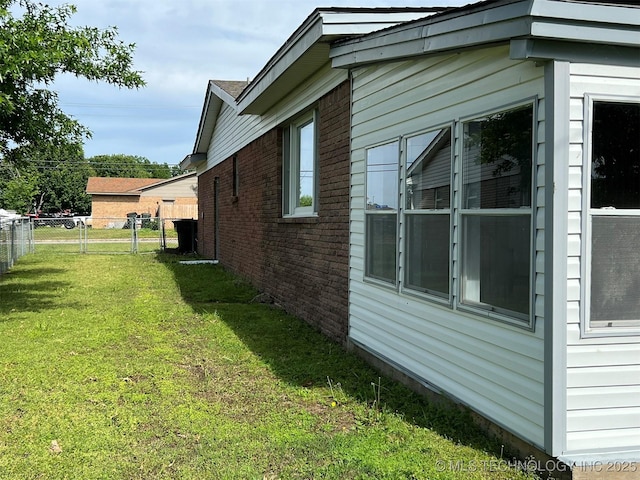 105 Hinton Blvd, Mannford, OK 74044 - view of side of property featuring a yard, brick siding, and fence