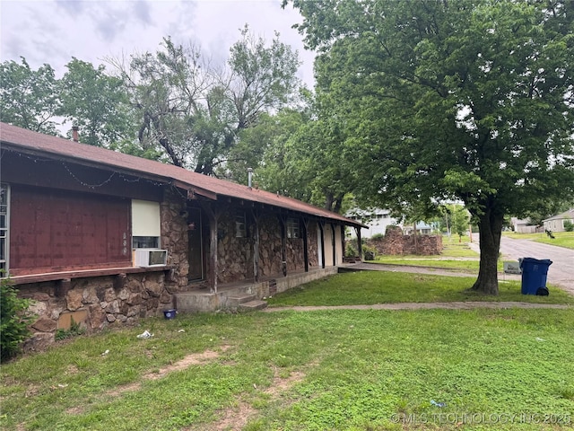 view of home's exterior featuring a yard and stone siding