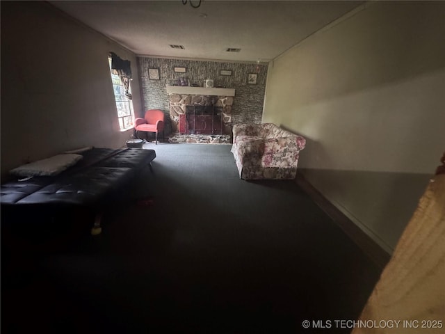 living room featuring a fireplace, carpet flooring, baseboards, and visible vents