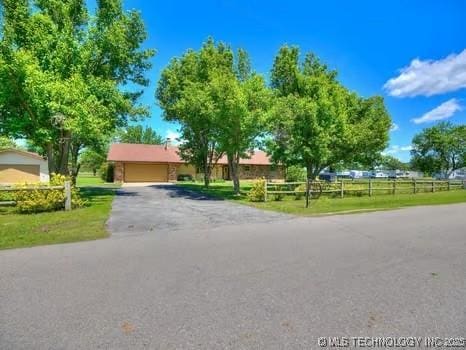 exterior space featuring a garage and fence