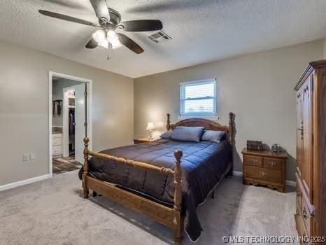 bedroom featuring a textured ceiling, visible vents, ceiling fan, carpet flooring, and baseboards