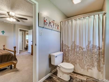 full bathroom with curtained shower, ceiling fan, toilet, and baseboards
