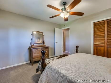 bedroom featuring ceiling fan, carpet flooring, baseboards, and a closet