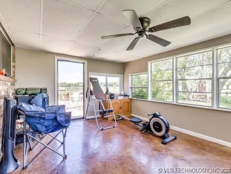 workout area featuring baseboards and ceiling fan
