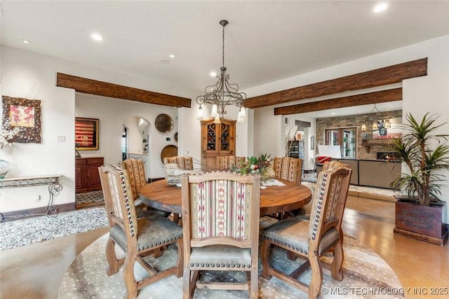 9639 Horizon Cir, Sperry, OK 74073 - dining area featuring arched walkways, a notable chandelier, recessed lighting, and baseboards