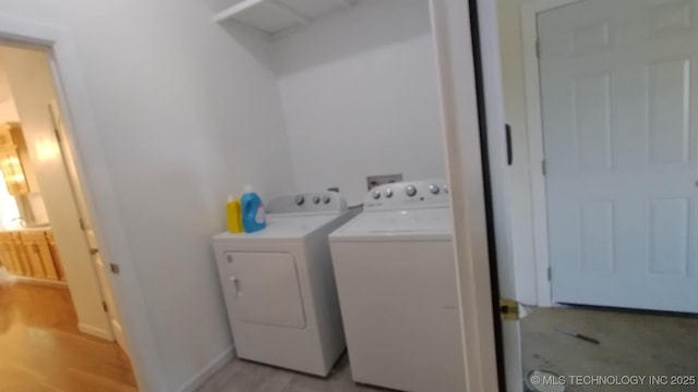 21316 County Road 502, Colcord, OK 74338 - laundry area featuring light wood finished floors, laundry area, washer and clothes dryer, and baseboards