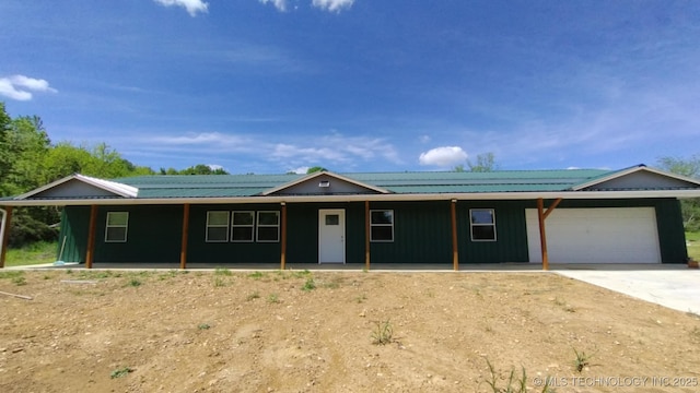 21316 County Road 502, Colcord, OK 74338 - single story home with covered porch, board and batten siding, an attached garage, and driveway