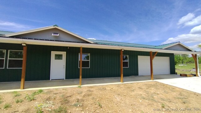 21316 County Road 502, Colcord, OK 74338 - view of front of property featuring metal roof, an attached garage, and driveway