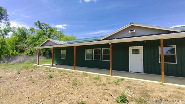21316 County Road 502, Colcord, OK 74338 - back of property featuring metal roof and board and batten siding