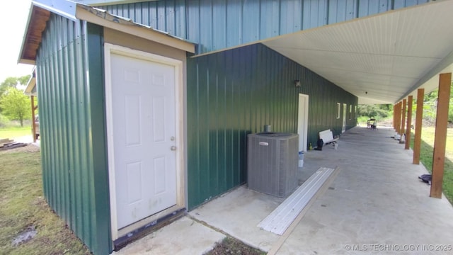 21316 County Road 502, Colcord, OK 74338 - property entrance featuring board and batten siding and central AC