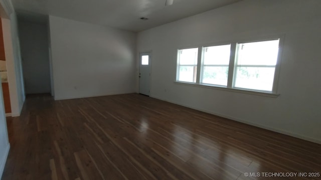 21316 County Road 502, Colcord, OK 74338 - unfurnished room with ceiling fan, baseboards, and dark wood-style floors