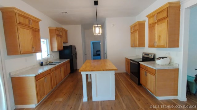 21316 County Road 502, Colcord, OK 74338 - kitchen featuring freestanding refrigerator, butcher block counters, light wood-type flooring, and stainless steel electric range