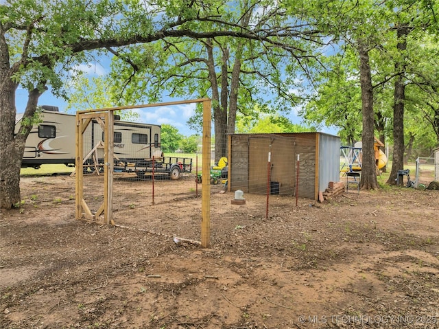 view of yard with an outbuilding, exterior structure, and fence