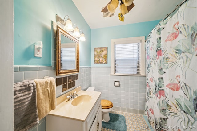1731 S Florence Pl, Tulsa, OK 74104 - bathroom featuring tile walls, toilet, a wainscoted wall, vanity, and a ceiling fan