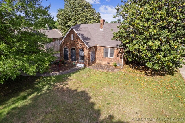 1731 S Florence Pl, Tulsa, OK 74104 - rear view of house with fence, brick siding, crawl space, a yard, and a chimney