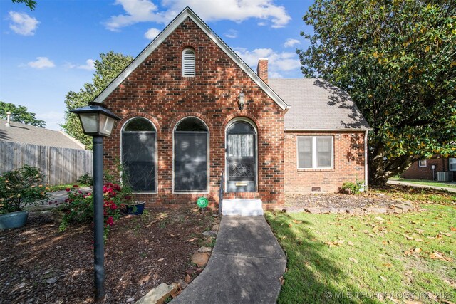 1731 S Florence Pl, Tulsa, OK 74104 - view of front of home featuring a chimney, brick siding, fence, a shingled roof, and crawl space