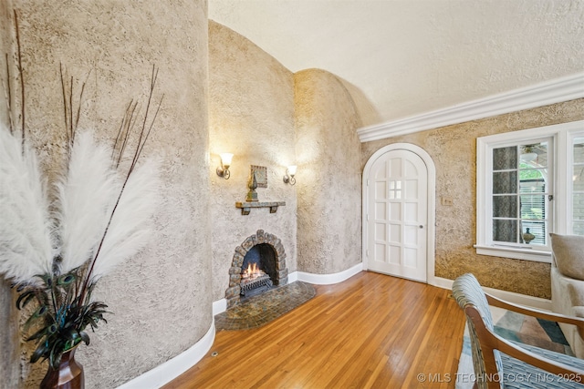 1731 S Florence Pl, Tulsa, OK 74104 - unfurnished living room featuring a lit fireplace, vaulted ceiling, baseboards, and wood finished floors