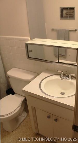 107 S 10th, Davis, OK 73030 - bathroom featuring vanity, tile walls, and wainscoting
