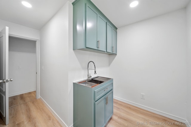 1402 E 125th St S, Jenks, OK 74037 - washroom with light wood finished floors, a sink, recessed lighting, and baseboards